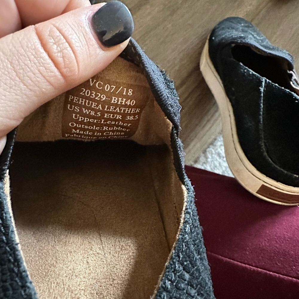 Black snakeskin slip on sneakers